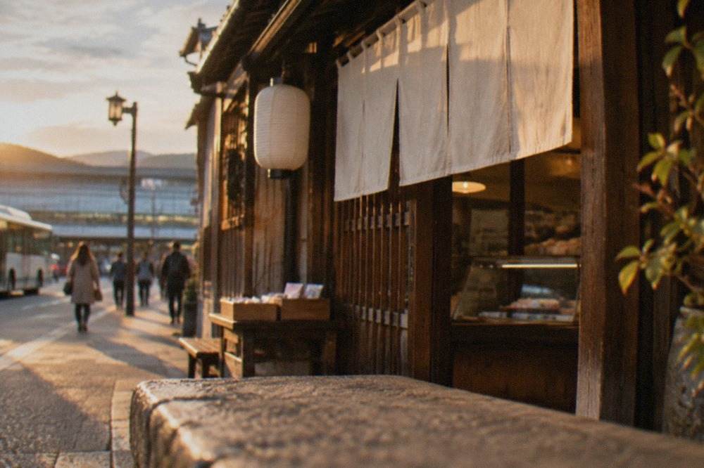A small traditional wooden sweet shop front in Kyoto with a curtain over the entrance
