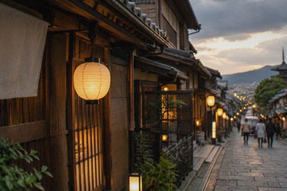 Evening view of a lantern-lit street in Kyoto with traditional wooden machiya facades