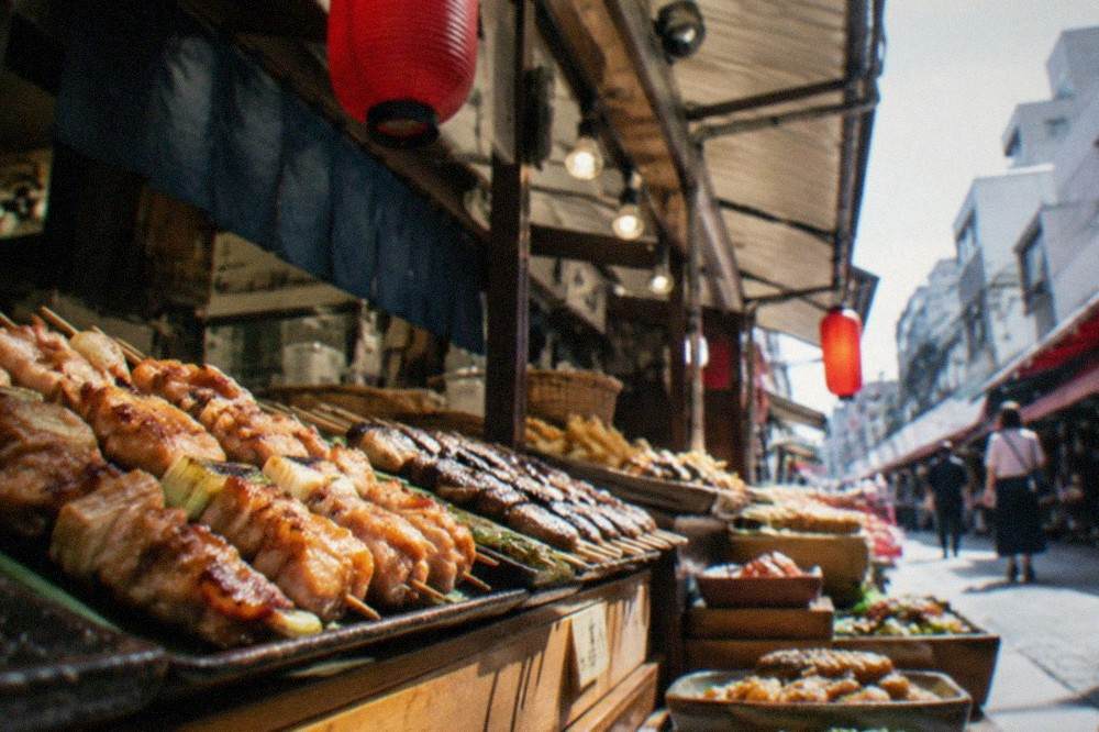 Fresh skewers and prepared dishes displayed at a covered Kyoto market stall