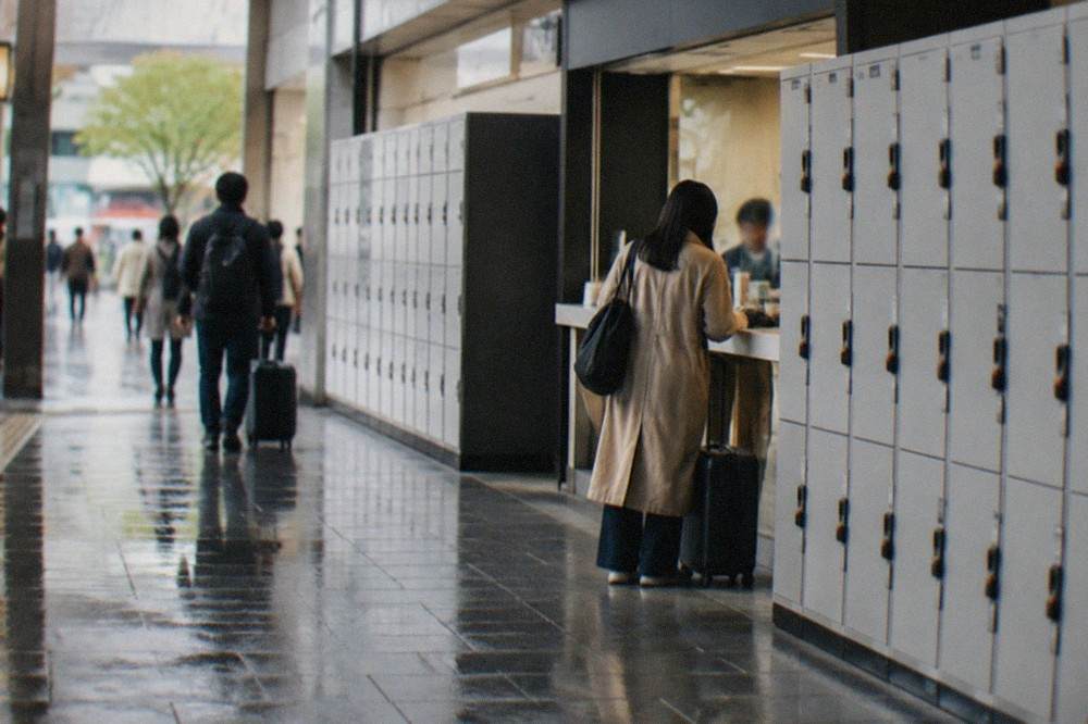 Lockers and a luggage storage counter along a station corridor