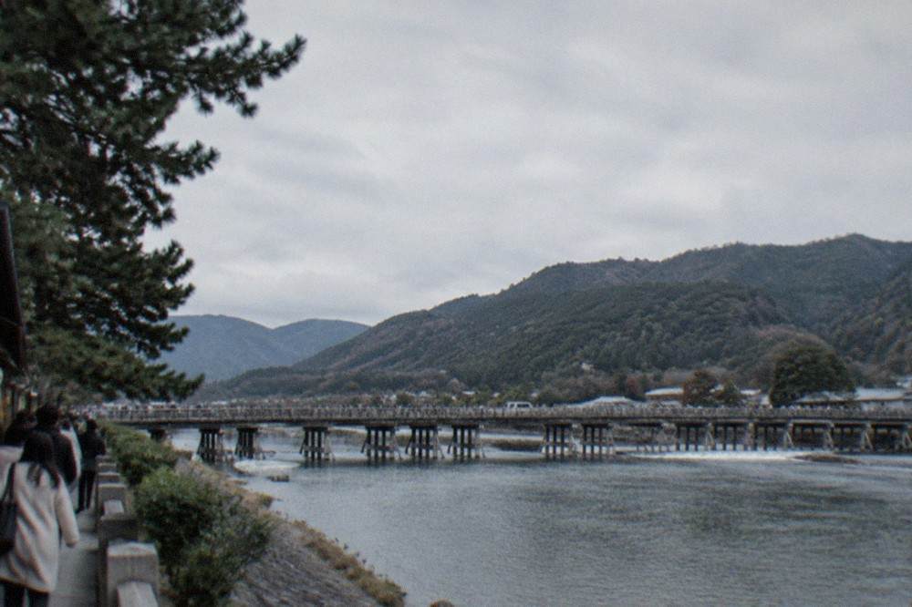 Togetsukyo bridge over the Katsura river with forested mountains behind, Arashiyama, Kyoto