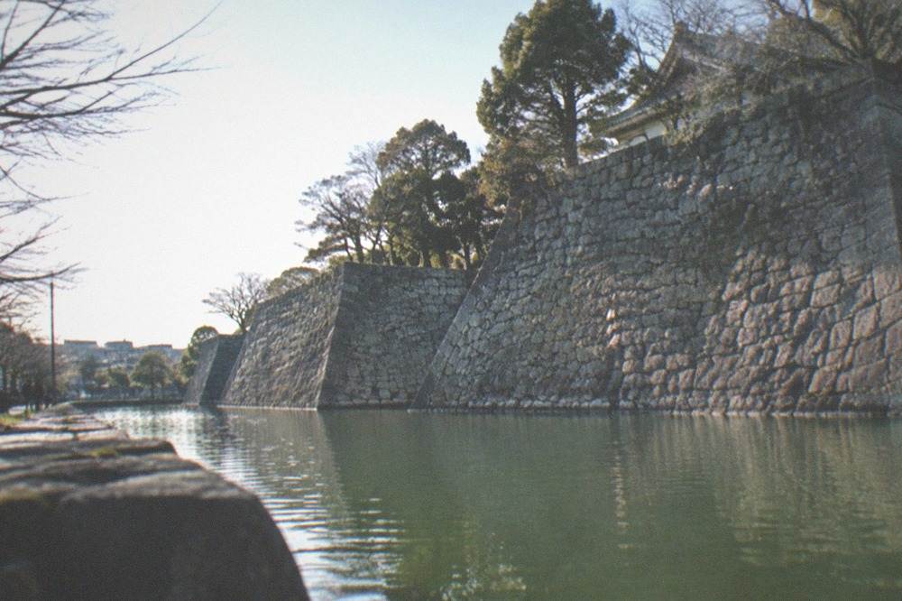 Stone walls and green moat of a castle ruin park in Fushimi, Kyoto