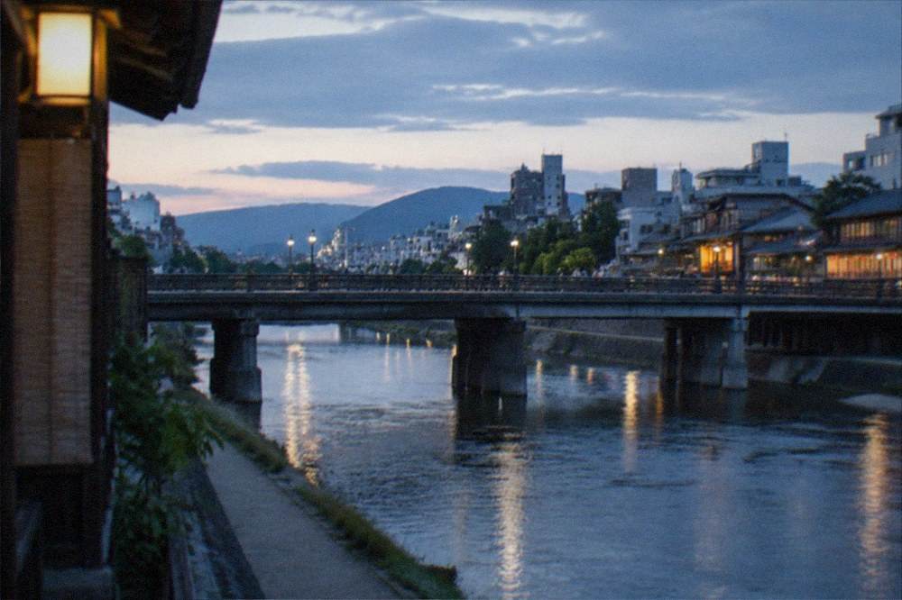 Shijo Bridge over the Kamo River at dusk with Gion beyond