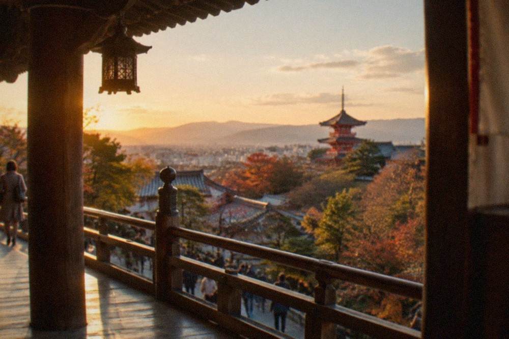 Wooden veranda of a hillside temple overlooking the city with a red pagoda in the distance