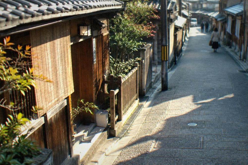 A quiet residential street in the Nishijin district with traditional wooden machiya houses