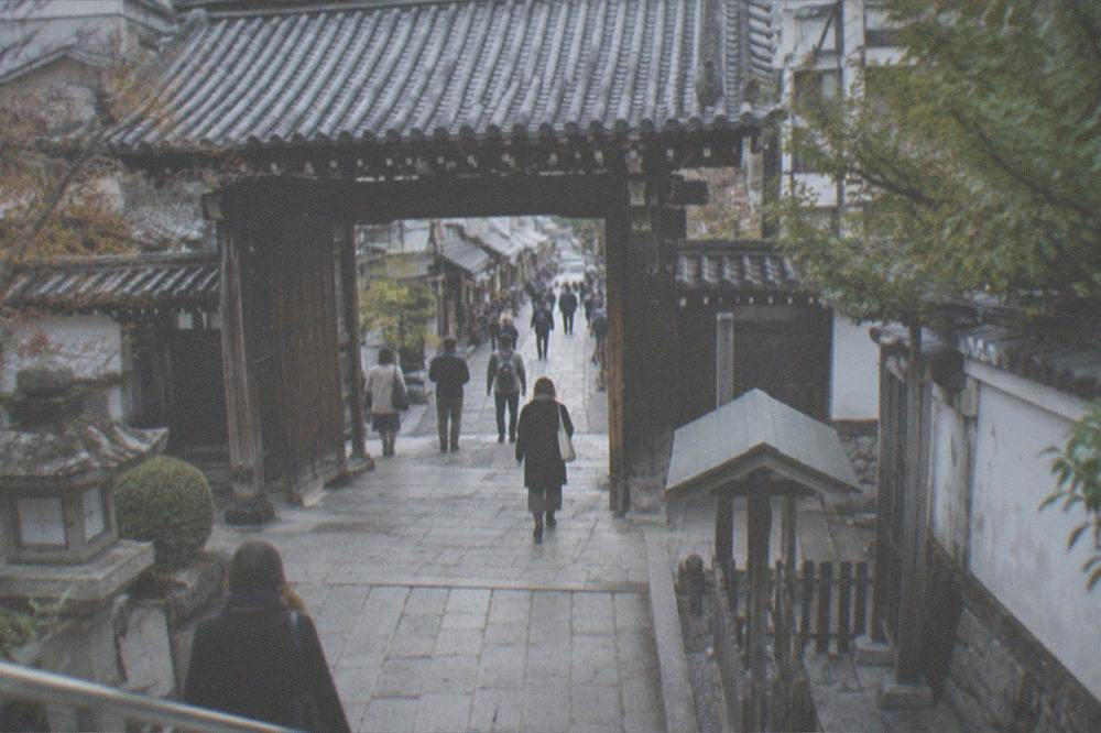 A temple gate and stone path a short walk from a downtown Kyoto arcade