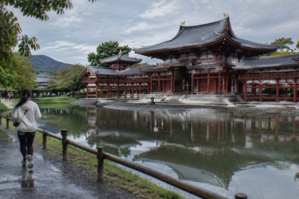 The Phoenix Hall of Byodo-in temple reflected in its pond in Uji, Kyoto