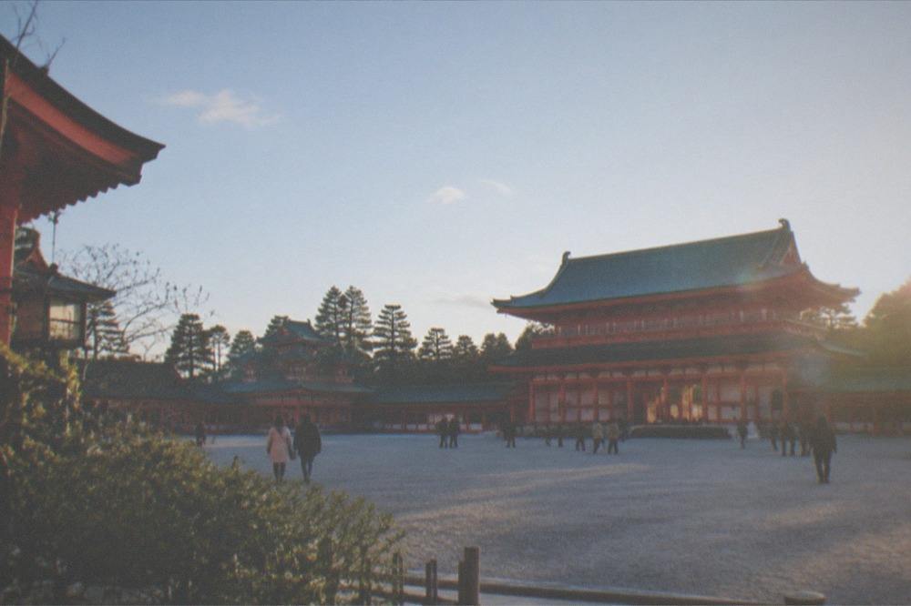 The red buildings of Heian Shrine seen across the wide courtyard
