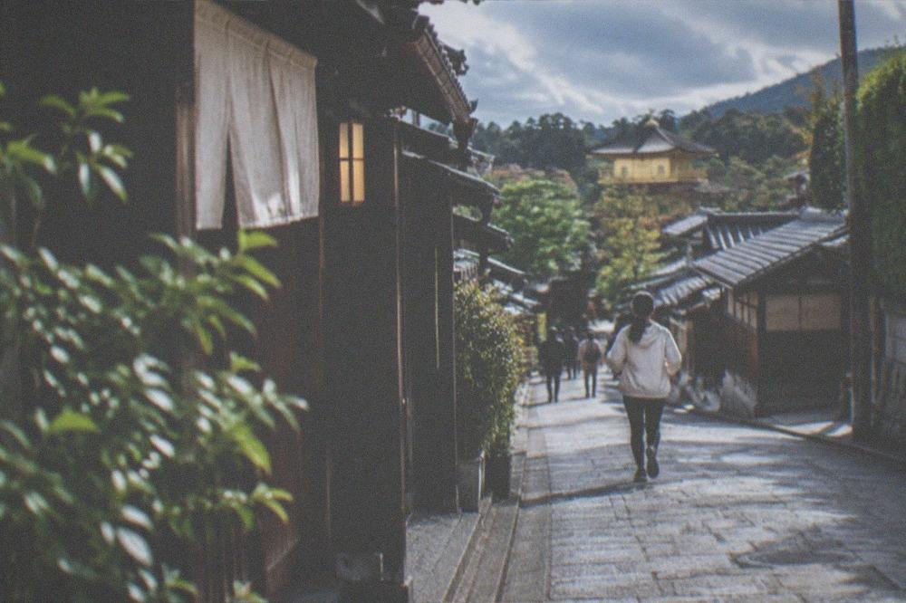 A quiet residential street with traditional wooden houses near the Golden Pavilion district
