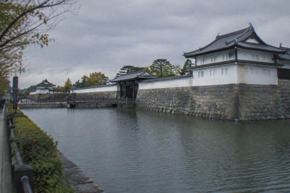 The stone walls and tiered roofs of Nijo-jo Castle seen from its wide outer moat