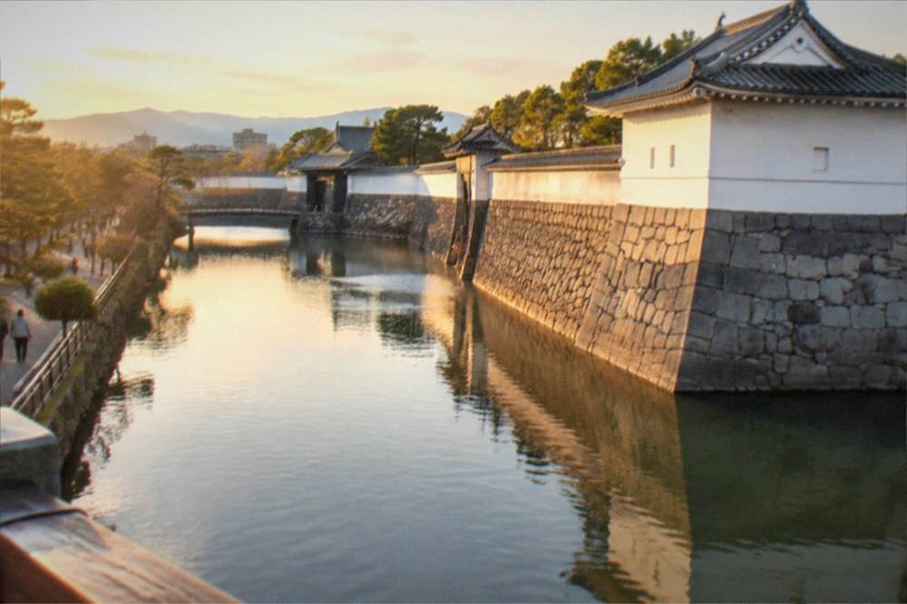 The outer moat and stone ramparts of Nijo Castle at golden hour