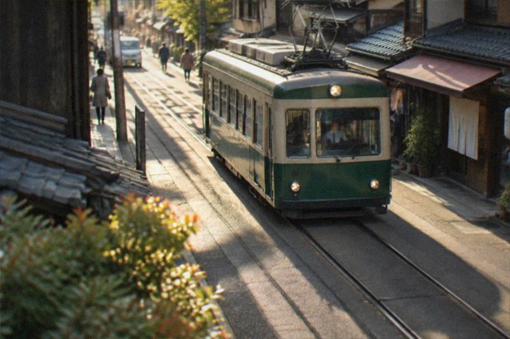 A single-car tram passing shops on a narrow Kyoto street