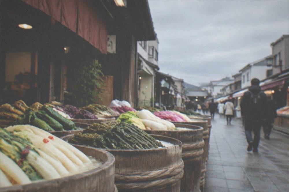 Rows of wooden pickle barrels filled with vegetables at a market shopfront