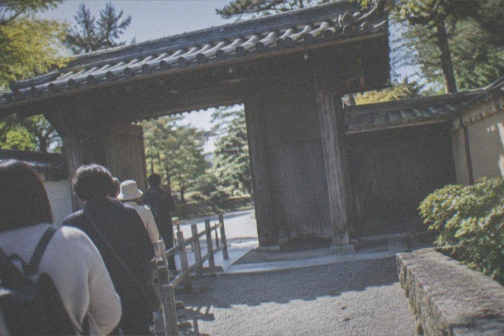 The villa entrance gate with a small queue of visitors waiting for a guided tour