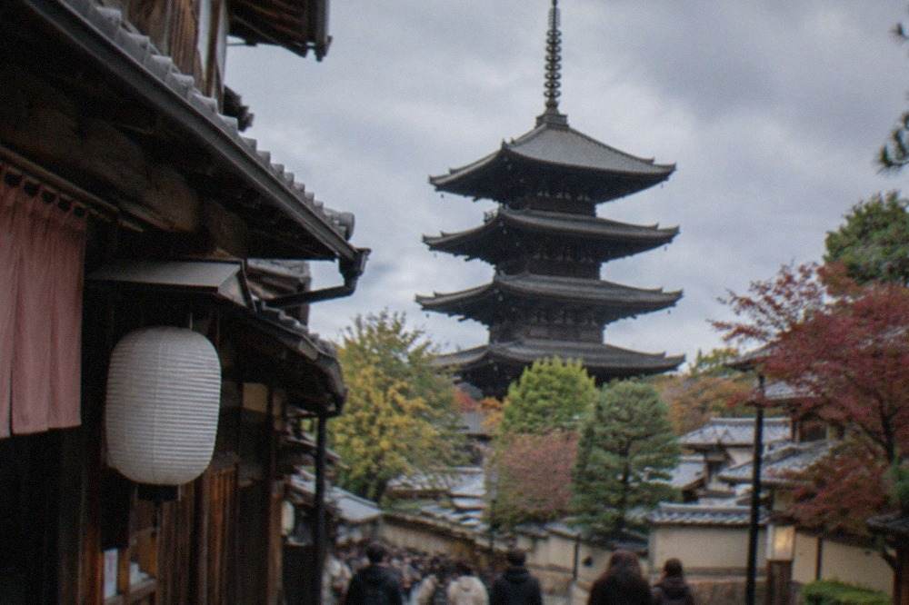 The five-story wooden pagoda of To-ji temple rising above trees in Kyoto