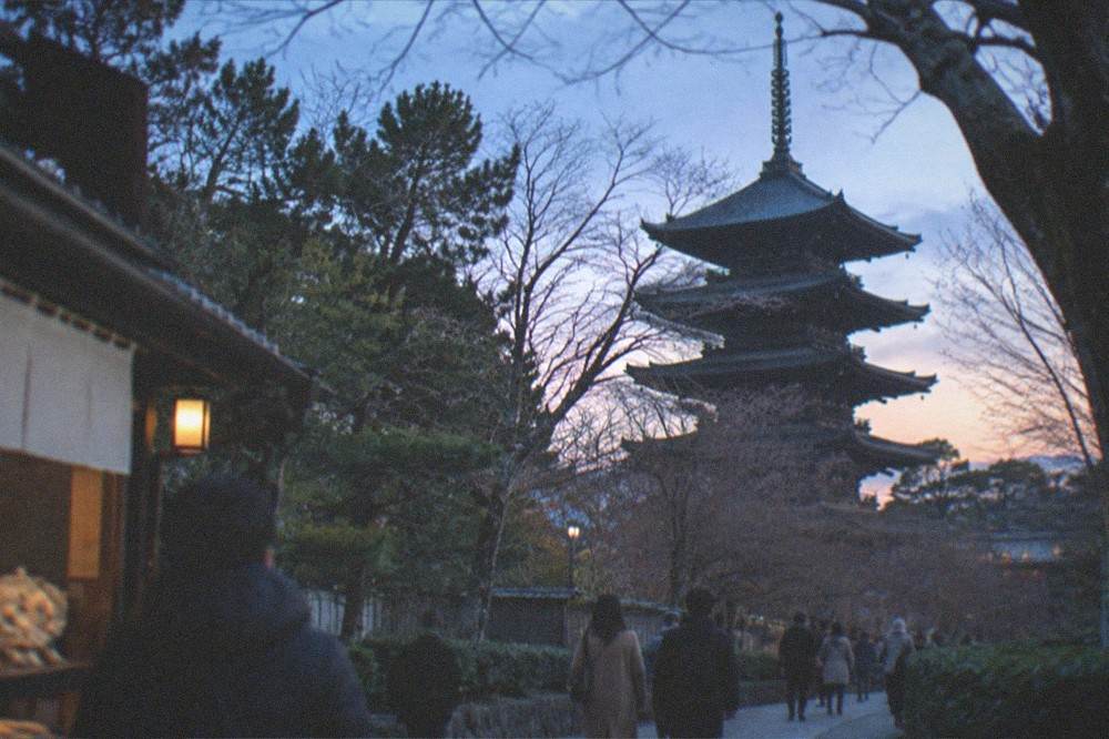 The To-ji pagoda seen through bare winter branches at dusk