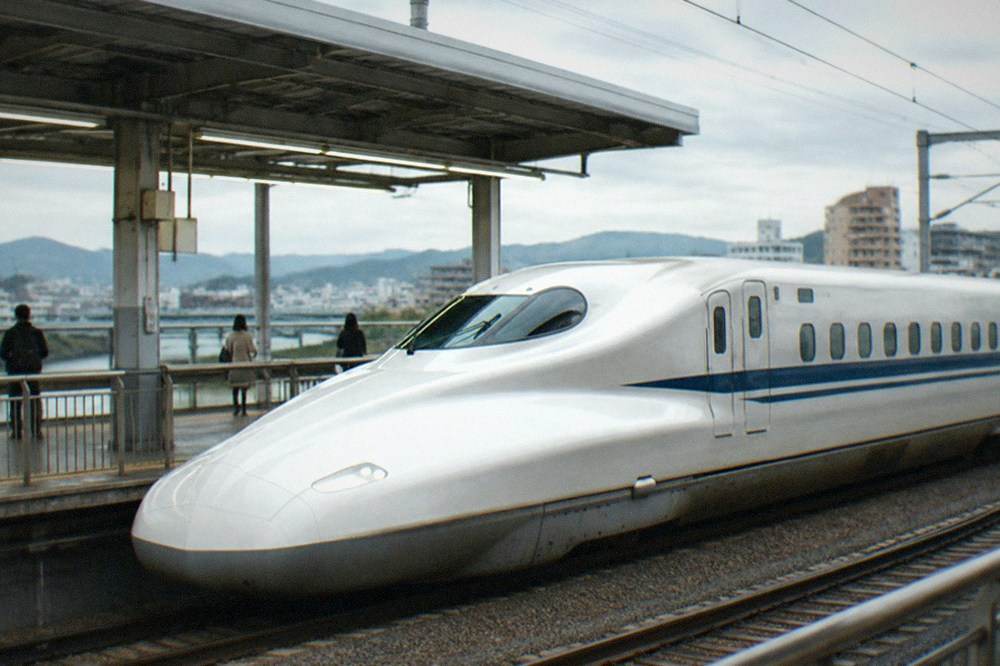 A shinkansen bullet train waiting at a station platform in Japan
