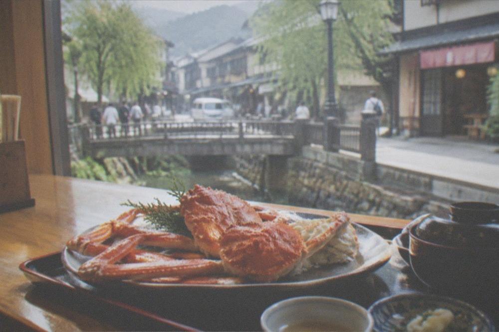 Fresh snow crab served on a lacquer tray at a wooden counter
