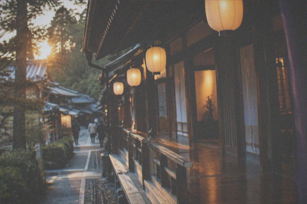Temple lodging corridor with paper lanterns glowing in the evening