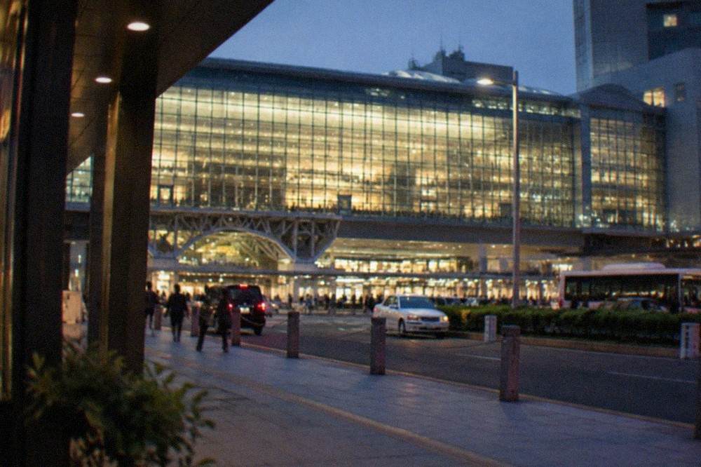 Kyoto Station building at night with its illuminated glass facade