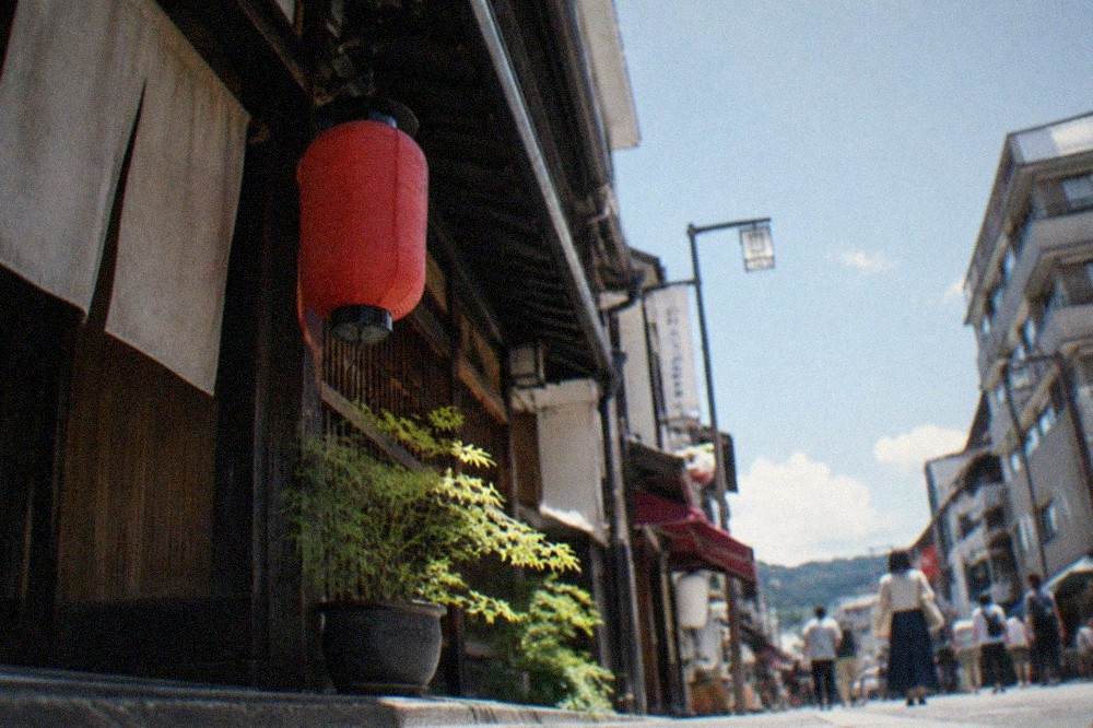 A formal kaiseki course arranged in lacquerware on a low wooden table in a tatami room