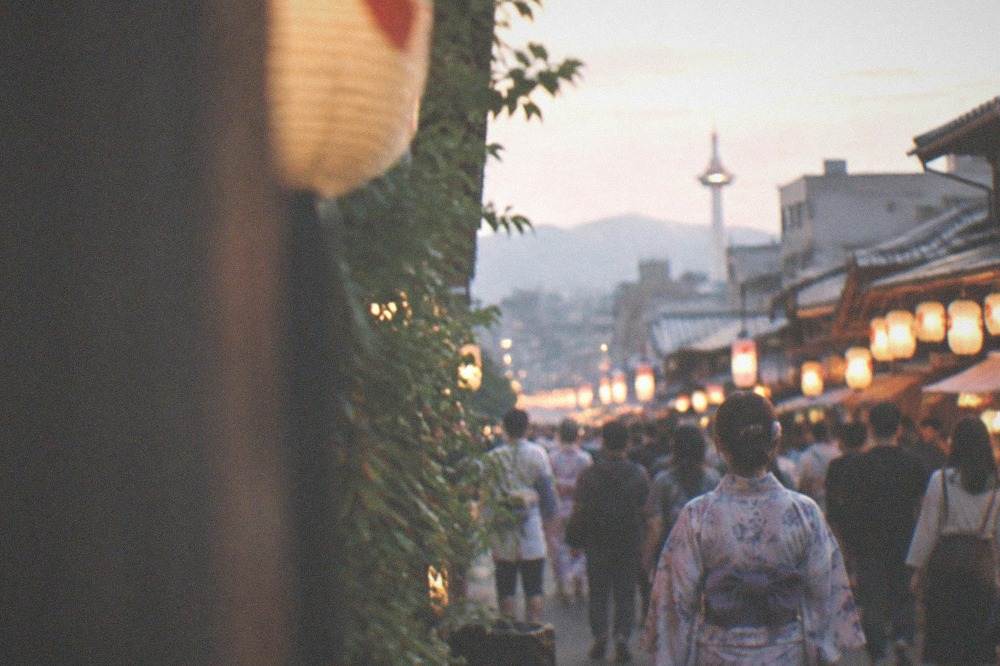 A crowded lantern-lit street in Kyoto during a festival evening