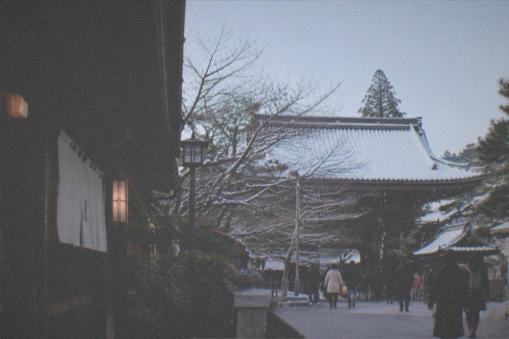 Snow resting on the roof of a Kyoto temple in winter under a clear sky