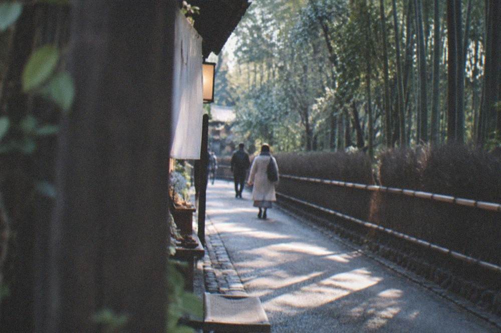 The bamboo path at Arashiyama in soft early morning light with few visitors