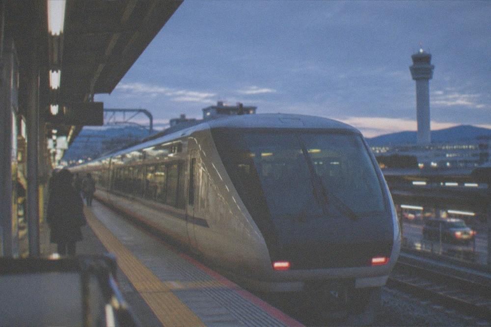 A limited express train waiting at an airport station platform