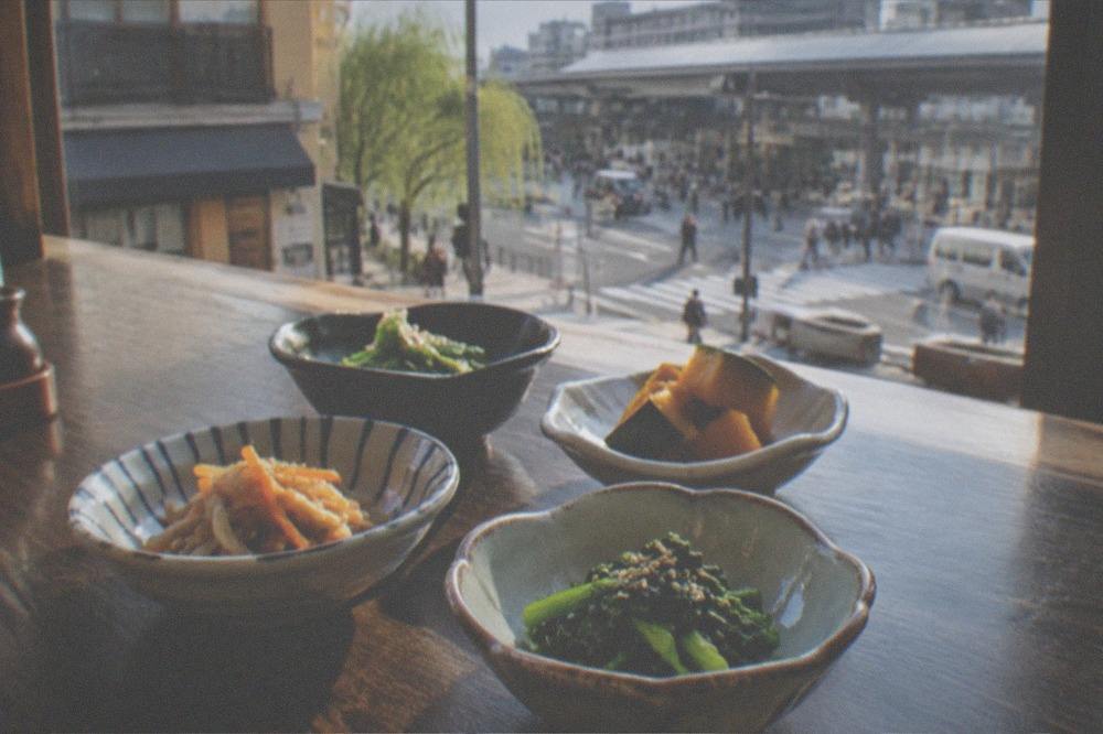 Small plates of seasoned vegetables arranged on a dark wooden table