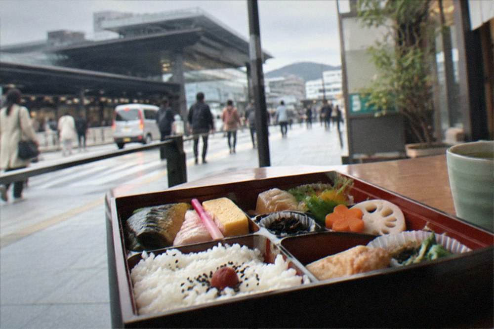 A lacquered bento box with compartments of seasonal food