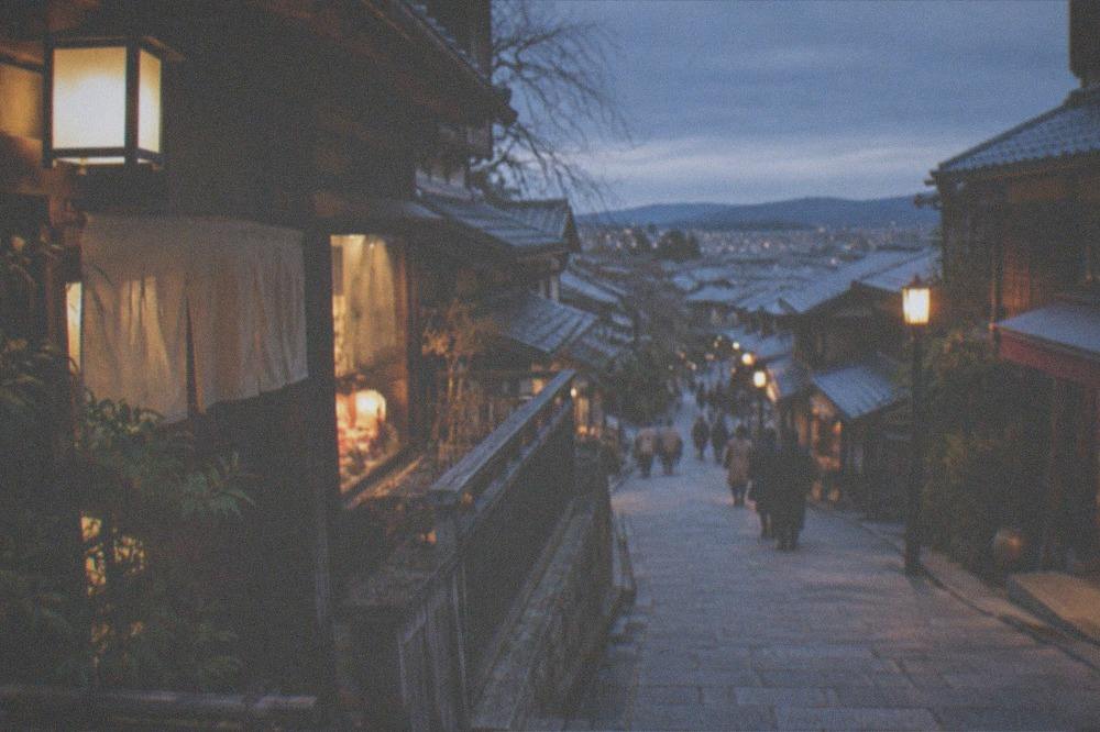A stone-paved sloping lane lined with traditional wooden shopfronts in Ninenzaka