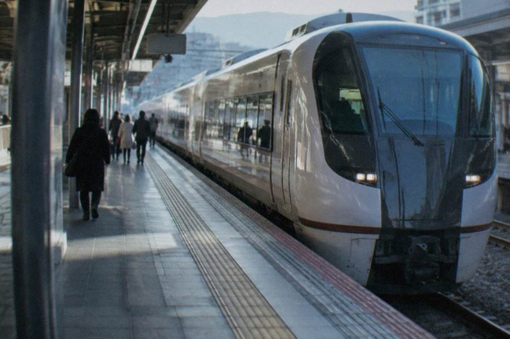 A limited express train standing at a platform in a Japanese railway station