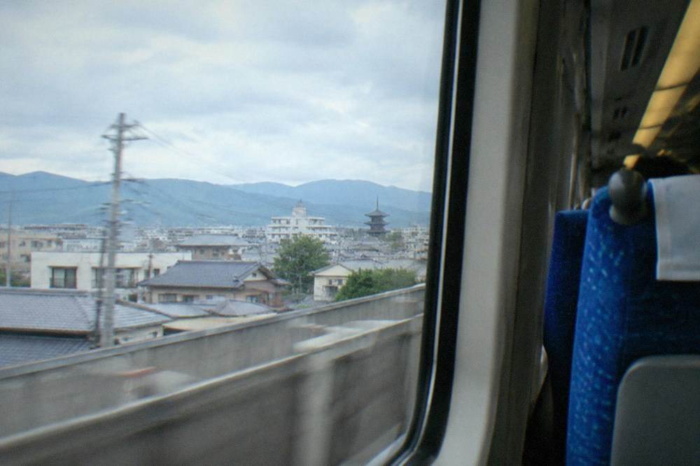 A sleek express train interior with rows of forward-facing seats and large windows