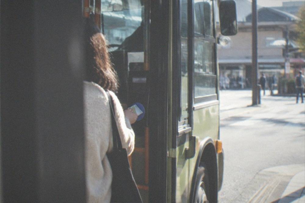 A traveller tapping an IC transit card on a bus card reader in Kyoto