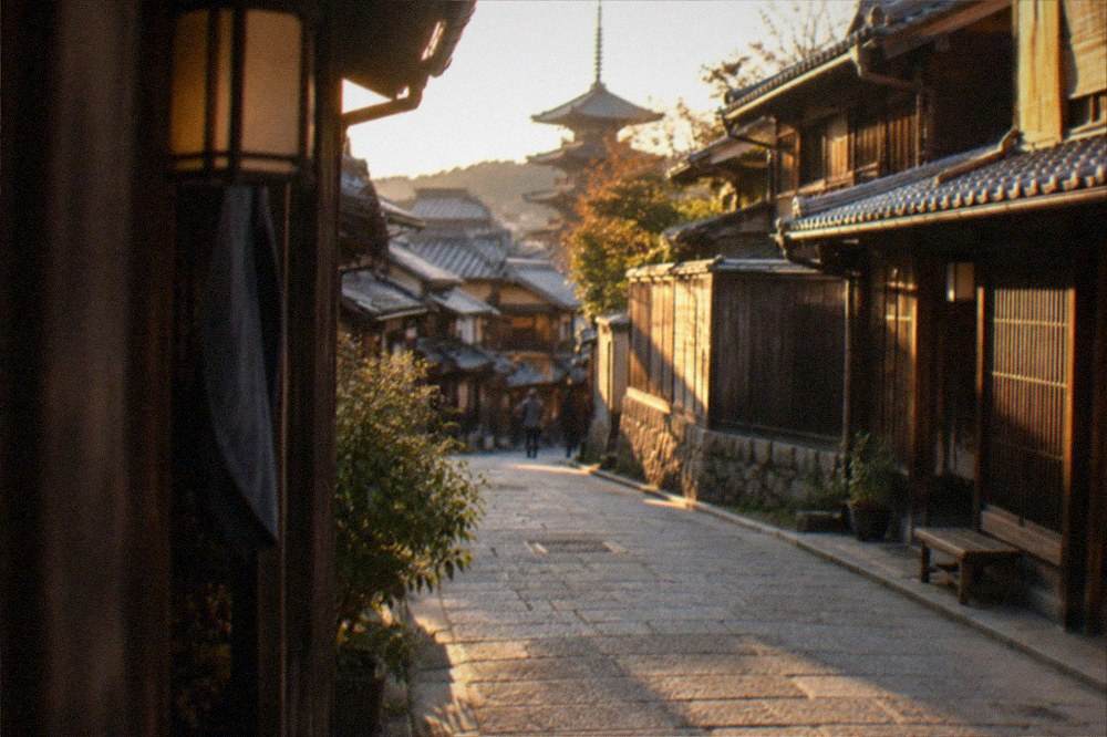 An early morning view of a nearly empty lane of traditional wooden machiya houses in Higashiyama