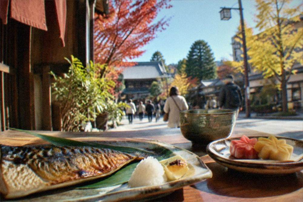 Autumn-themed Kyoto dishes with maple-leaf-shaped sweets and grilled fish on ceramic plates