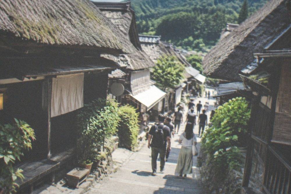 A preserved thatched roof village street in rural Kyoto with traditional farmhouses