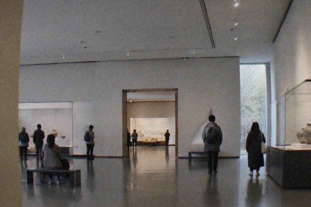 Gallery hall of a Kyoto museum with visitors viewing displays