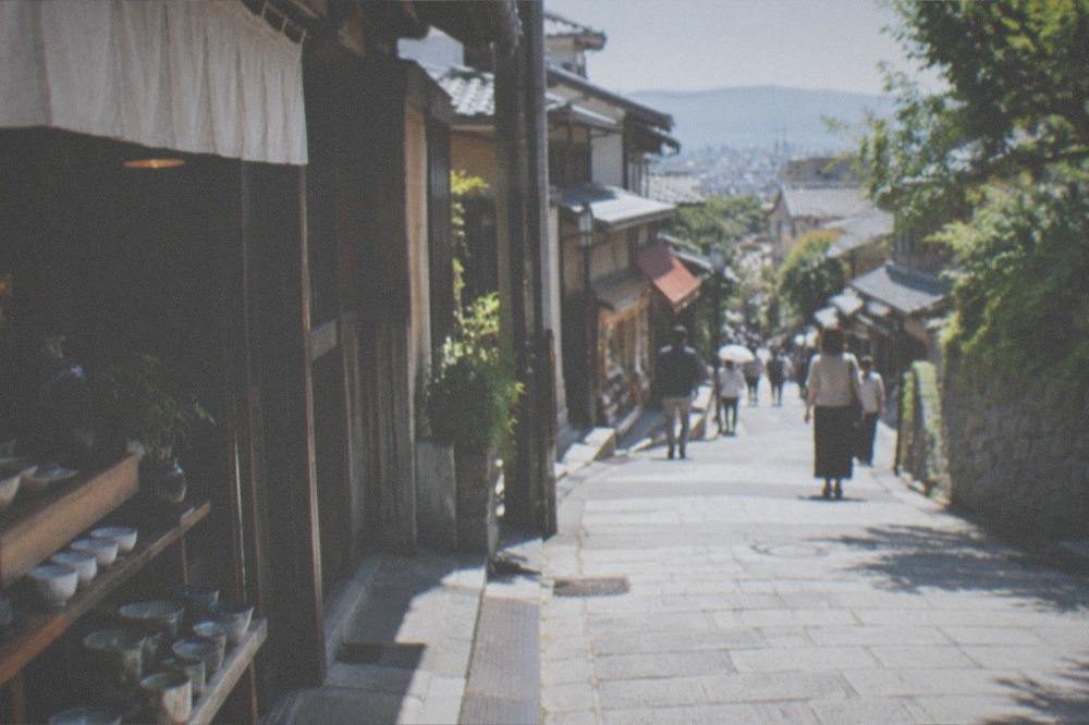 Wooden sake barrels stacked at a brewery entrance in the Fushimi district of Kyoto