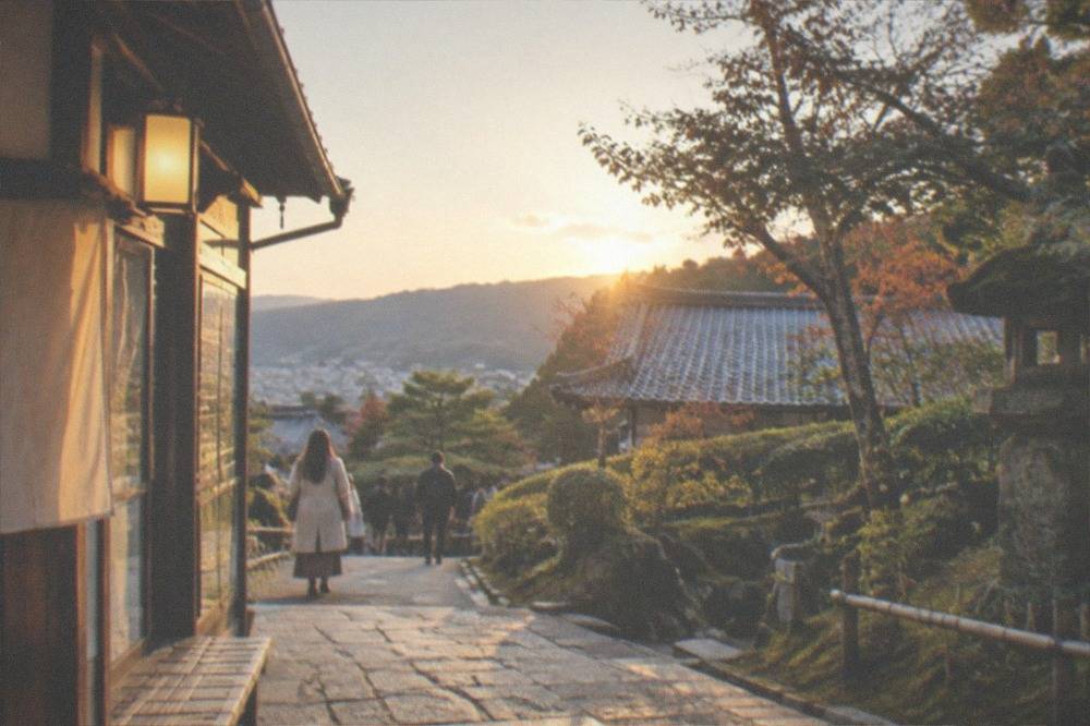 A stone path leading through moss-covered temple gardens in a rural valley