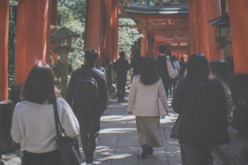 Commuters and travellers passing through a modern subway station concourse in Kyoto