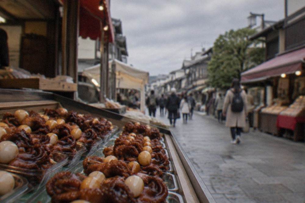 Small glazed baby octopus snacks with quail eggs arranged in a display case