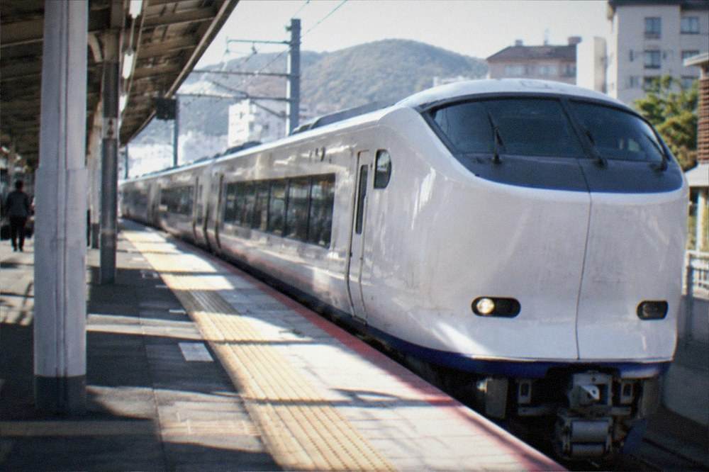 The white JR HARUKA express train standing at a Kansai airport station platform