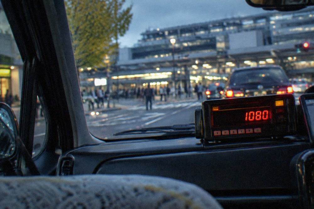 A taxi meter display showing a fare in Japanese yen inside a Kyoto taxi at night