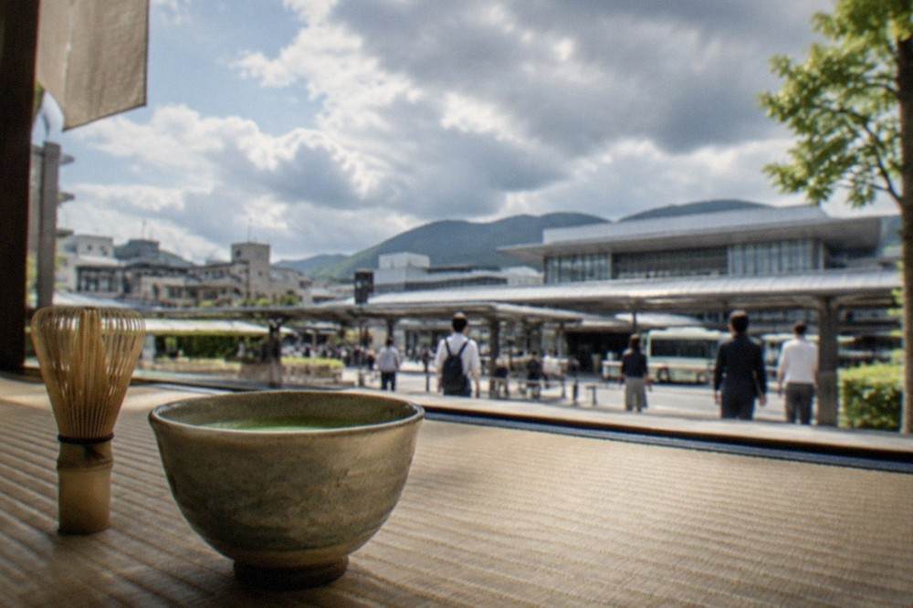 Bamboo tea whisk and bowl of matcha on a tatami floor