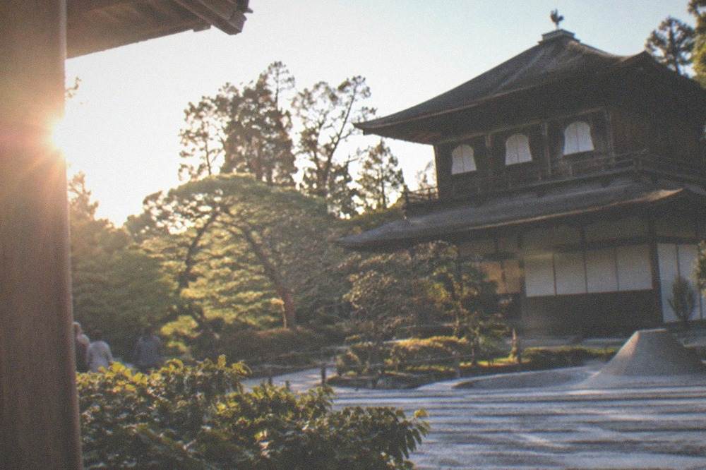 Silver pavilion of Ginkaku-ji beside its raked sand garden under a clear sky