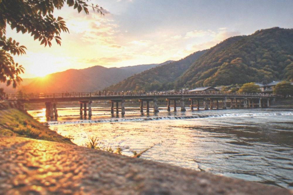 Togetsukyo bridge over the Katsura river in Arashiyama with wooded hills behind