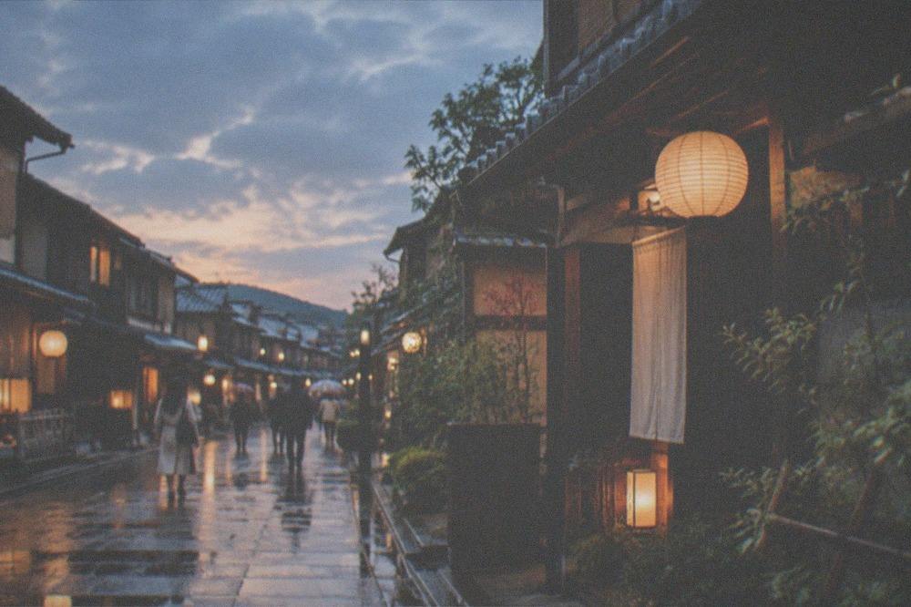 A traditional machiya townhouse street in Naramachi at dusk with lanterns lit