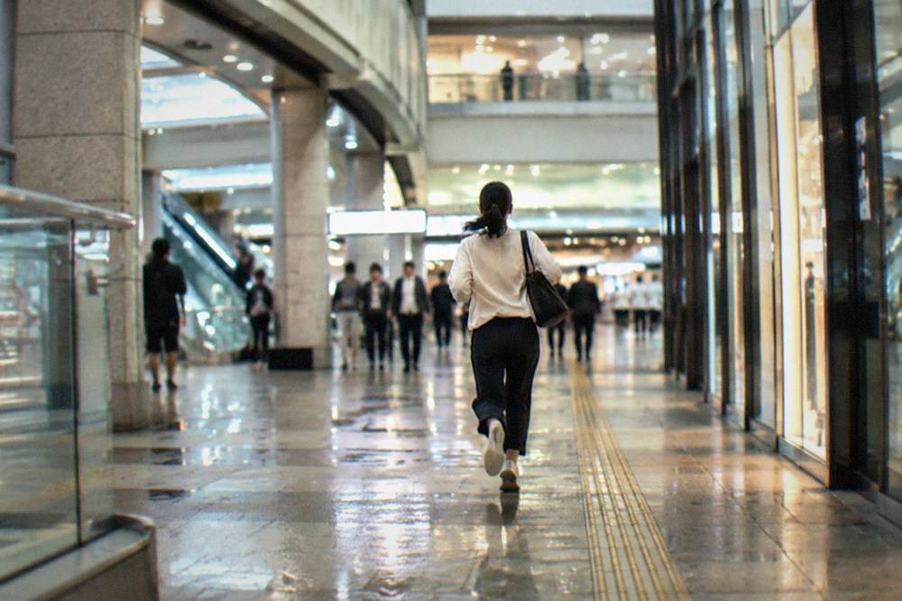 The large multi-level concourse of Umeda Station with direction signs in Japanese and English